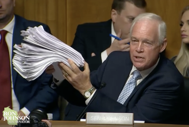 Fauci_hearing_paper_stack.png Image